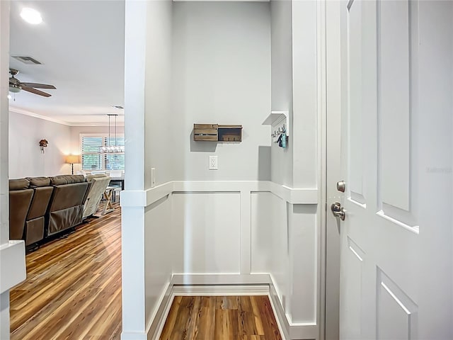 20749 Swallowtail Ct, Venice, FL 34293 - hall featuring wood finished floors, crown molding, and a chandelier