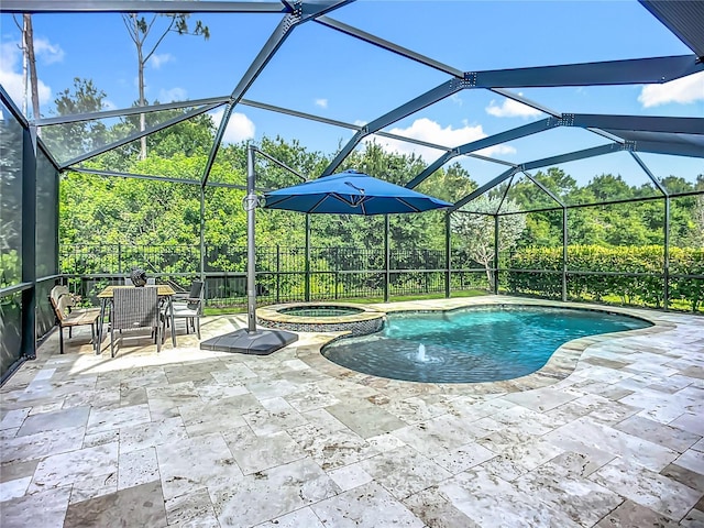 20749 Swallowtail Ct, Venice, FL 34293 - view of swimming pool featuring a pool with connected hot tub, a patio, a fenced backyard, and a lanai