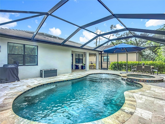 20749 Swallowtail Ct, Venice, FL 34293 - view of swimming pool featuring a patio, a pool with connected hot tub, area for grilling, and glass enclosure