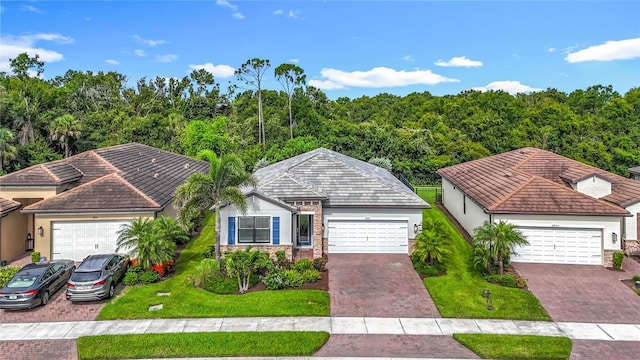 20749 Swallowtail Ct, Venice, FL 34293 - ranch-style home with stucco siding, a front lawn, stone siding, and decorative driveway