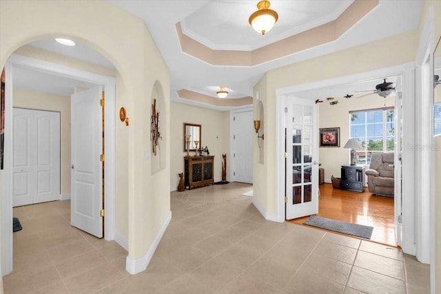 157 Tampa Ave E Unit 305, Venice, FL 34285 - foyer entrance featuring arched walkways, light tile patterned floors, ceiling fan, and a raised ceiling