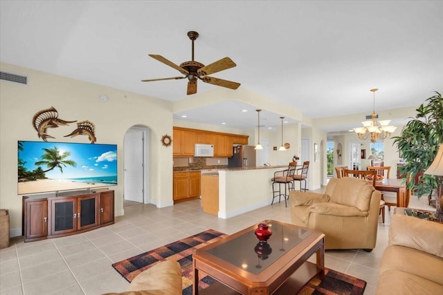 157 Tampa Ave E Unit 305, Venice, FL 34285 - living room with light tile patterned floors, a chandelier, arched walkways, and ceiling fan