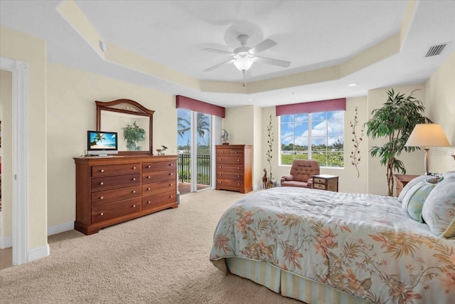 157 Tampa Ave E Unit 305, Venice, FL 34285 - bedroom featuring a raised ceiling, access to exterior, carpet floors, and a ceiling fan