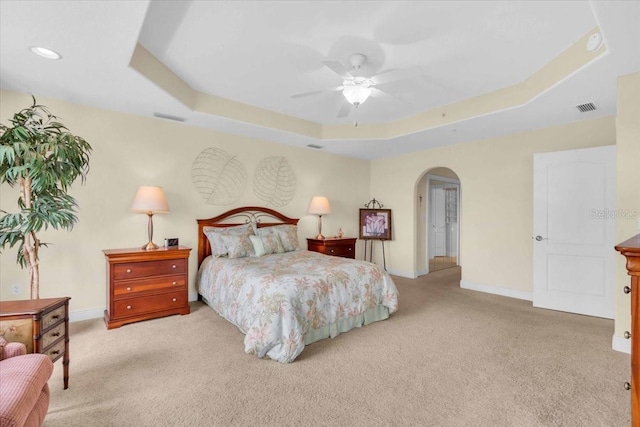 157 Tampa Ave E Unit 305, Venice, FL 34285 - carpeted bedroom featuring arched walkways, a raised ceiling, and a ceiling fan