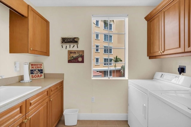 157 Tampa Ave E Unit 305, Venice, FL 34285 - washroom with cabinet space, washing machine and dryer, and light tile patterned floors