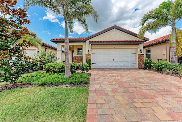257 Teramo Way, Nokomis, FL 34275 - mediterranean / spanish-style home featuring stucco siding, decorative driveway, and an attached garage