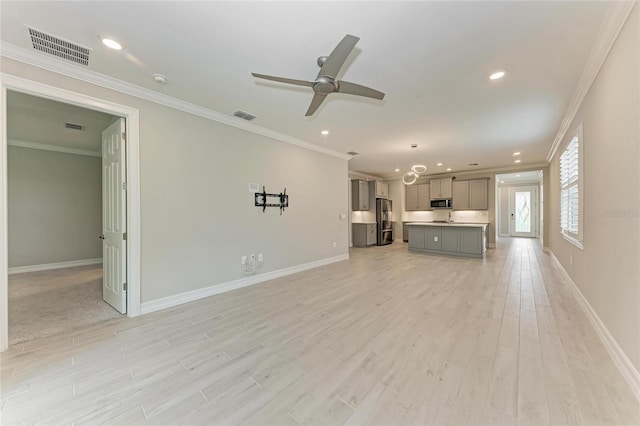 257 Teramo Way, Nokomis, FL 34275 - unfurnished living room with light wood-style floors, recessed lighting, ornamental molding, and a ceiling fan