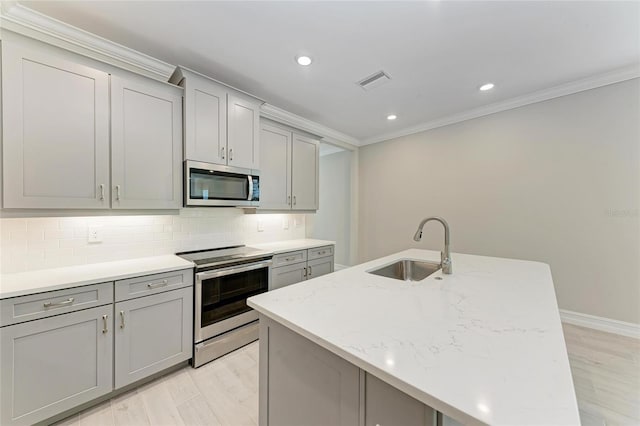 257 Teramo Way, Nokomis, FL 34275 - kitchen featuring stainless steel appliances, gray cabinets, ornamental molding, light wood-style floors, and recessed lighting