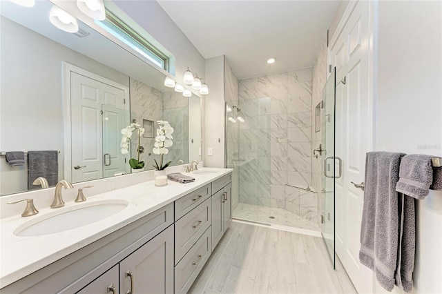 257 Teramo Way, Nokomis, FL 34275 - bathroom with double vanity, a stall shower, wood finished floors, and recessed lighting