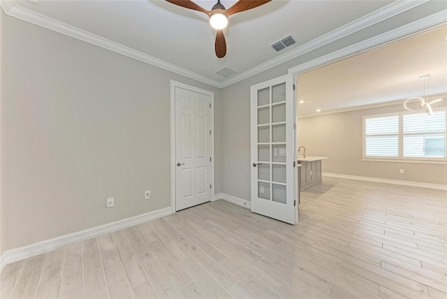 257 Teramo Way, Nokomis, FL 34275 - empty room featuring french doors, light wood-style flooring, ceiling fan, crown molding, and a chandelier