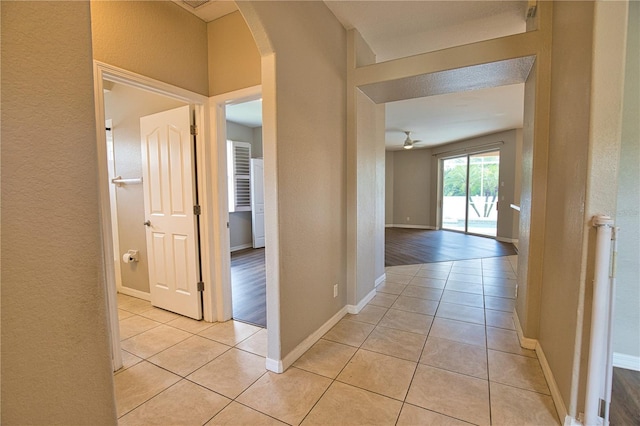 4150 Otoole St, North Port, FL 34291 - hallway featuring a textured wall, arched walkways, and light tile patterned floors