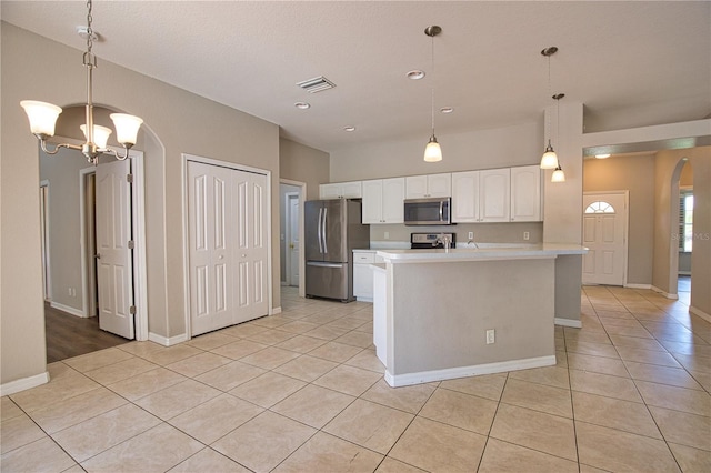 4150 Otoole St, North Port, FL 34291 - kitchen with appliances with stainless steel finishes, arched walkways, light tile patterned floors, light countertops, and white cabinetry