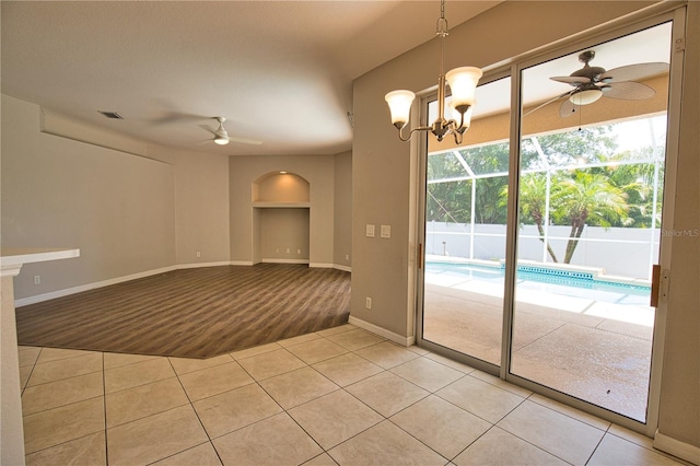4150 Otoole St, North Port, FL 34291 - empty room with ceiling fan, light tile patterned flooring, light carpet, and arched walkways