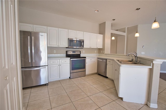 4150 Otoole St, North Port, FL 34291 - kitchen with stainless steel appliances, a peninsula, light tile patterned floors, light countertops, and white cabinetry