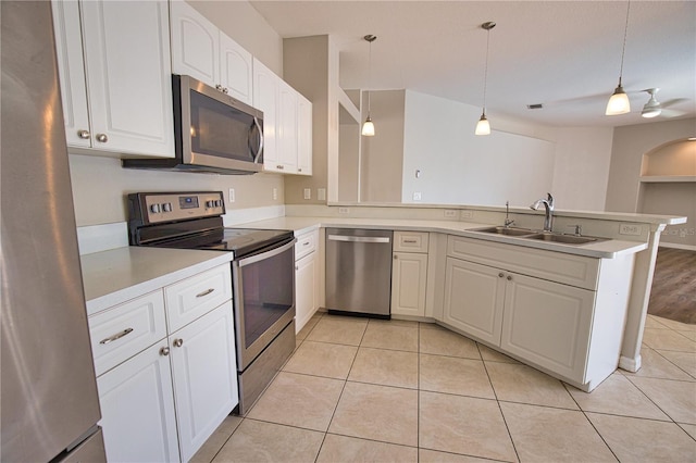 4150 Otoole St, North Port, FL 34291 - kitchen featuring appliances with stainless steel finishes, a peninsula, white cabinets, light countertops, and pendant lighting