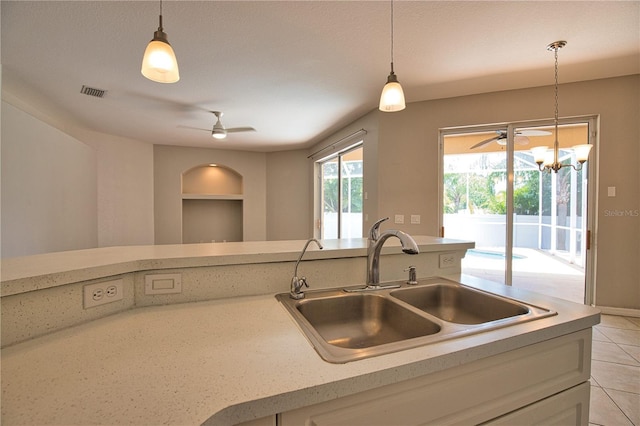 4150 Otoole St, North Port, FL 34291 - kitchen featuring a ceiling fan, light countertops, decorative light fixtures, and light tile patterned flooring