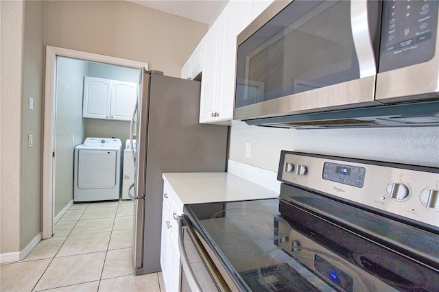 4150 Otoole St, North Port, FL 34291 - kitchen with stainless steel appliances, washer and clothes dryer, white cabinets, light tile patterned floors, and light countertops