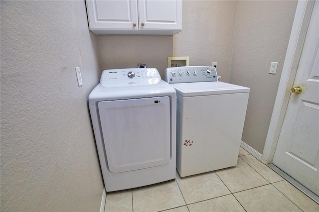 4150 Otoole St, North Port, FL 34291 - laundry room featuring independent washer and dryer, a textured wall, cabinet space, and light tile patterned floors