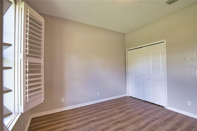 4150 Otoole St, North Port, FL 34291 - unfurnished bedroom with dark wood-style flooring and a closet