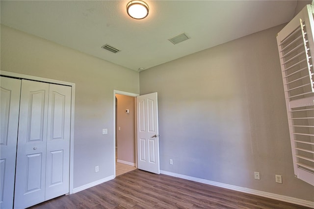 4150 Otoole St, North Port, FL 34291 - unfurnished bedroom with dark wood finished floors and a closet
