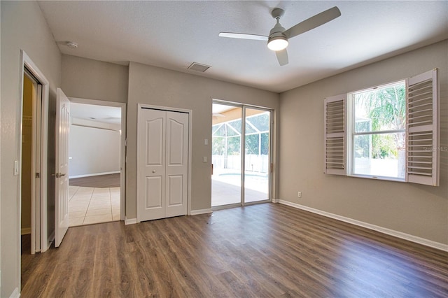 4150 Otoole St, North Port, FL 34291 - unfurnished room featuring healthy amount of natural light, dark wood-style floors, ceiling fan, and a smoke detector