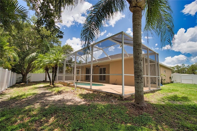4150 Otoole St, North Port, FL 34291 - rear view of property featuring a fenced backyard, stucco siding, a patio, ceiling fan, and a lanai