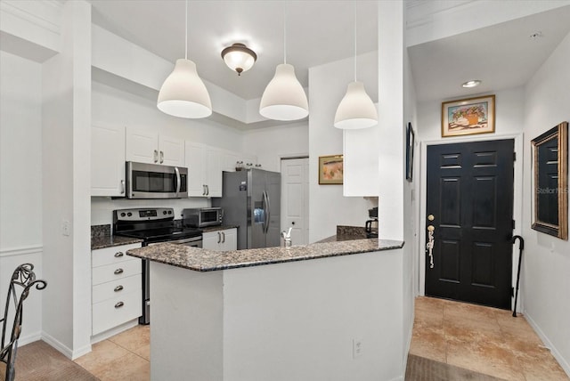 5134 Northridge Rd Unit 303, Sarasota, FL 34238 - kitchen with stainless steel appliances, white cabinets, dark stone counters, and light tile patterned flooring