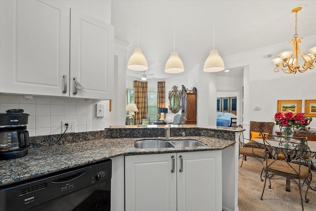 5134 Northridge Rd Unit 303, Sarasota, FL 34238 - kitchen with black dishwasher, a chandelier, white cabinetry, a peninsula, and decorative backsplash