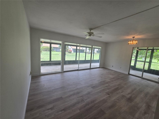 624 White Pine Tree Rd Unit 5, Venice, FL 34285 - spare room with healthy amount of natural light, a chandelier, ceiling fan, and dark wood-type flooring