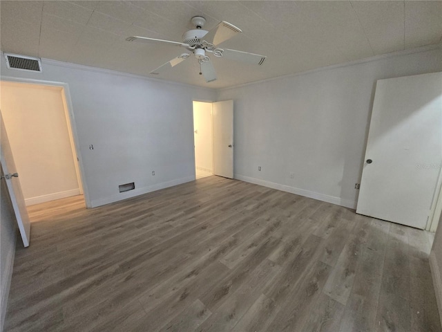 624 White Pine Tree Rd Unit 5, Venice, FL 34285 - unfurnished bedroom with wood finished floors, crown molding, and a ceiling fan