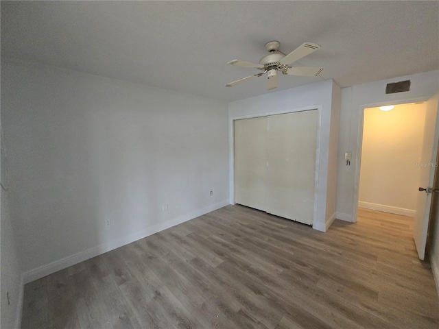 624 White Pine Tree Rd Unit 5, Venice, FL 34285 - unfurnished bedroom with wood finished floors, a closet, and ceiling fan