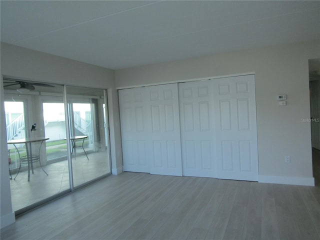 999 Inlet Cir Unit D101, Venice, FL 34285 - unfurnished bedroom featuring wood finished floors, access to exterior, and a closet