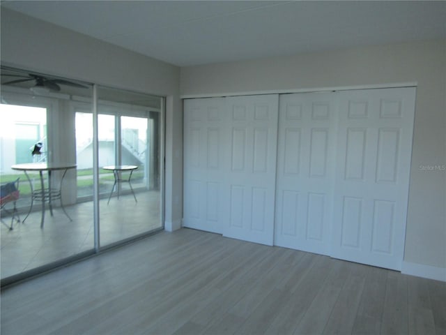 999 Inlet Cir Unit D101, Venice, FL 34285 - unfurnished bedroom with access to outside, wood finished floors, and a closet