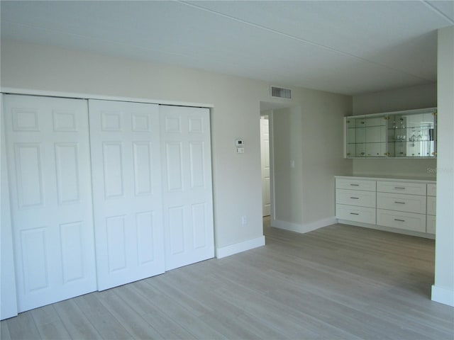 999 Inlet Cir Unit D101, Venice, FL 34285 - unfurnished bedroom with light wood-style floors and a closet