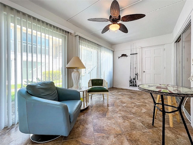 999 Inlet Cir Unit D101, Venice, FL 34285 - sitting room with plenty of natural light, a ceiling fan, and stone finish floors