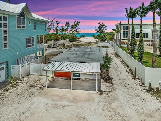616 S Casey Key Rd, Nokomis, FL 34275 - patio terrace at dusk featuring a water view and a fenced backyard