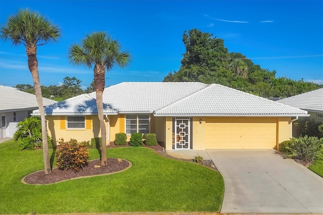 1614 Quail Lake Dr, Venice, FL 34293 - ranch-style home with an attached garage, a front yard, driveway, a tile roof, and stucco siding