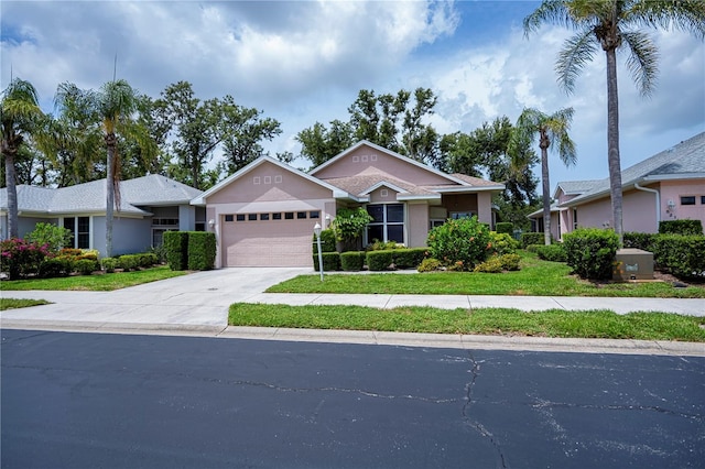 519 Catalina Isles Cir, Venice, FL 34292 - view of front of property with an attached garage, driveway, and stucco siding