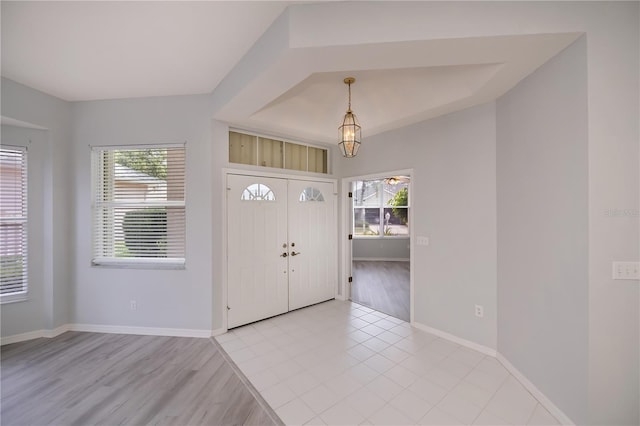519 Catalina Isles Cir, Venice, FL 34292 - foyer entrance featuring plenty of natural light, a chandelier, and light wood finished floors