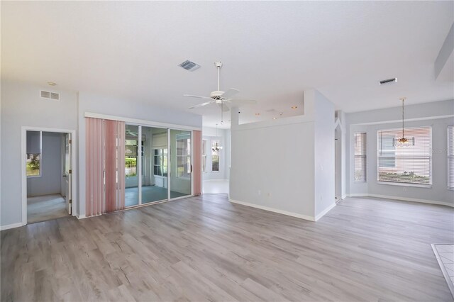519 Catalina Isles Cir, Venice, FL 34292 - unfurnished living room featuring healthy amount of natural light, a chandelier, ceiling fan, and light wood-style floors