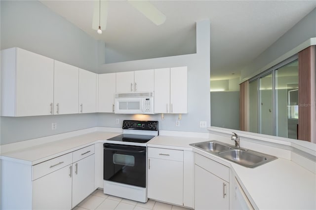 519 Catalina Isles Cir, Venice, FL 34292 - kitchen featuring white microwave, range with electric cooktop, light countertops, white cabinets, and lofted ceiling