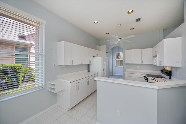 519 Catalina Isles Cir, Venice, FL 34292 - kitchen featuring white appliances, ceiling fan, light countertops, a peninsula, and light tile patterned flooring