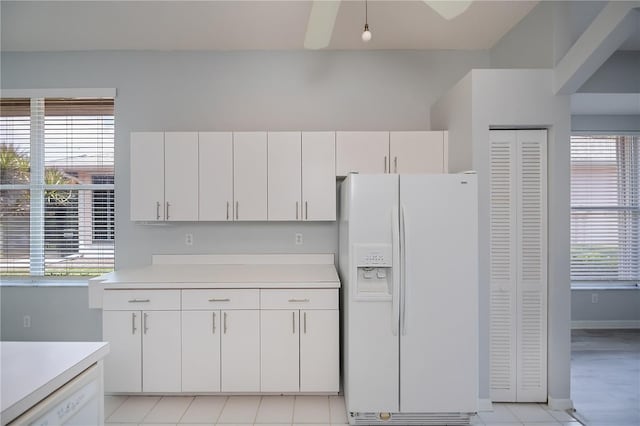 519 Catalina Isles Cir, Venice, FL 34292 - kitchen with white appliances, light countertops, and white cabinetry