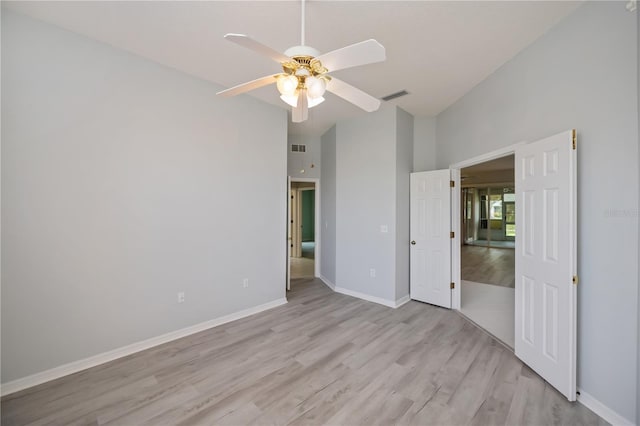 519 Catalina Isles Cir, Venice, FL 34292 - unfurnished bedroom with high vaulted ceiling, wood finished floors, and a ceiling fan