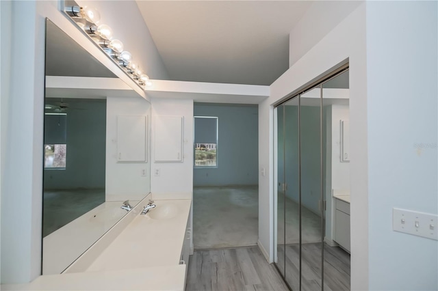 519 Catalina Isles Cir, Venice, FL 34292 - bathroom with vanity, wood finished floors, and ceiling fan