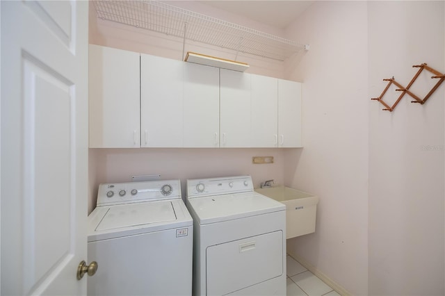 519 Catalina Isles Cir, Venice, FL 34292 - laundry area featuring cabinet space, washer and clothes dryer, and light tile patterned flooring
