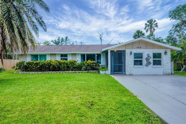 386 Nightingale Rd, Venice, FL 34293 - ranch-style house with stone siding and driveway