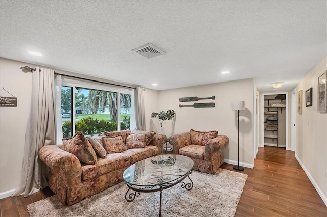 386 Nightingale Rd, Venice, FL 34293 - living room with wood finished floors, a textured ceiling, and recessed lighting