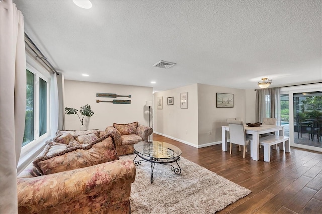 386 Nightingale Rd, Venice, FL 34293 - living room with dark wood finished floors, a textured ceiling, and recessed lighting