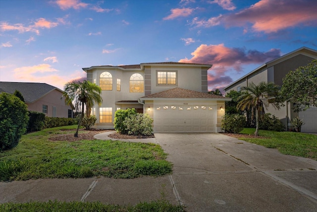 9528 Knightsbridge Cir, Sarasota, FL 34238 - view of front of house with stucco siding, concrete driveway, and a garage